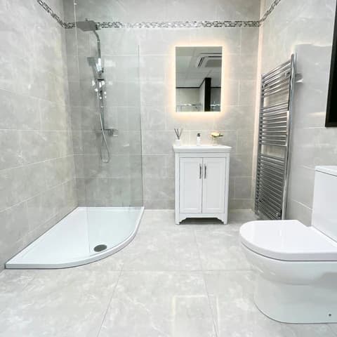 Bathroom wall and floor tiling being installed